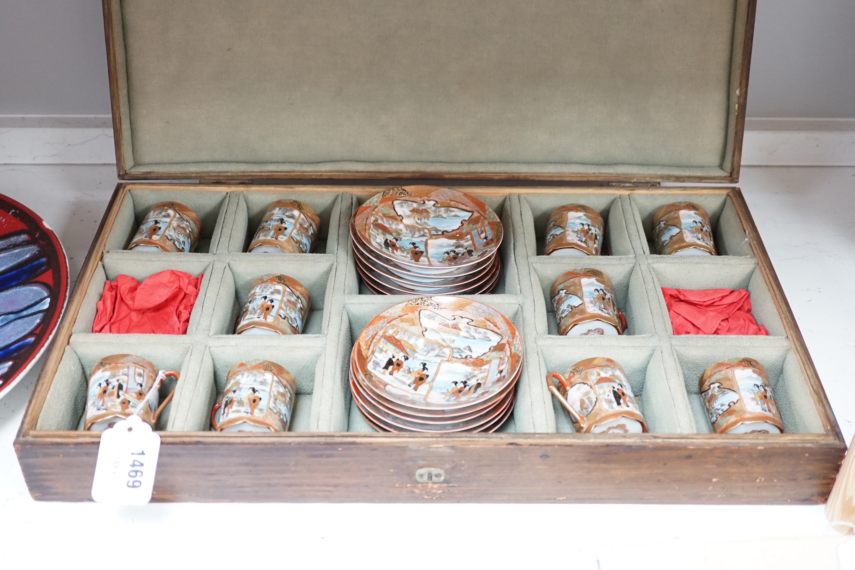 A Japanese Imari coffee set, cased, comprising ten coffee cans and twelve saucers in a lined wooden case, 53.5cm x 30cm x 9cm